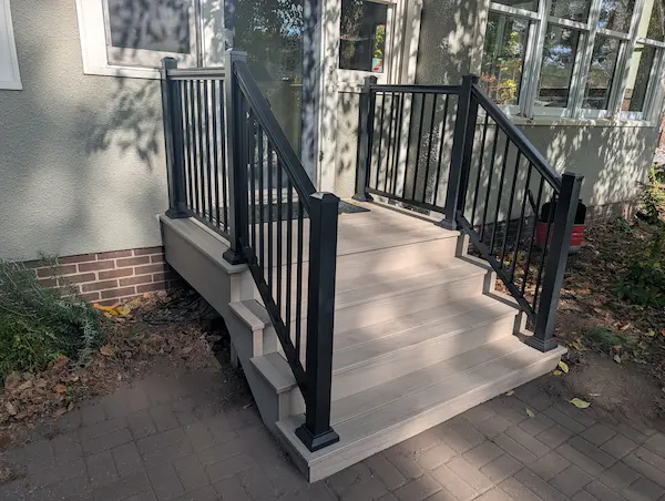 Renovated front entry deck in Merriam Park, St. Paul, MN featuring WOLF PVC Beechwood decking and black aluminum railings