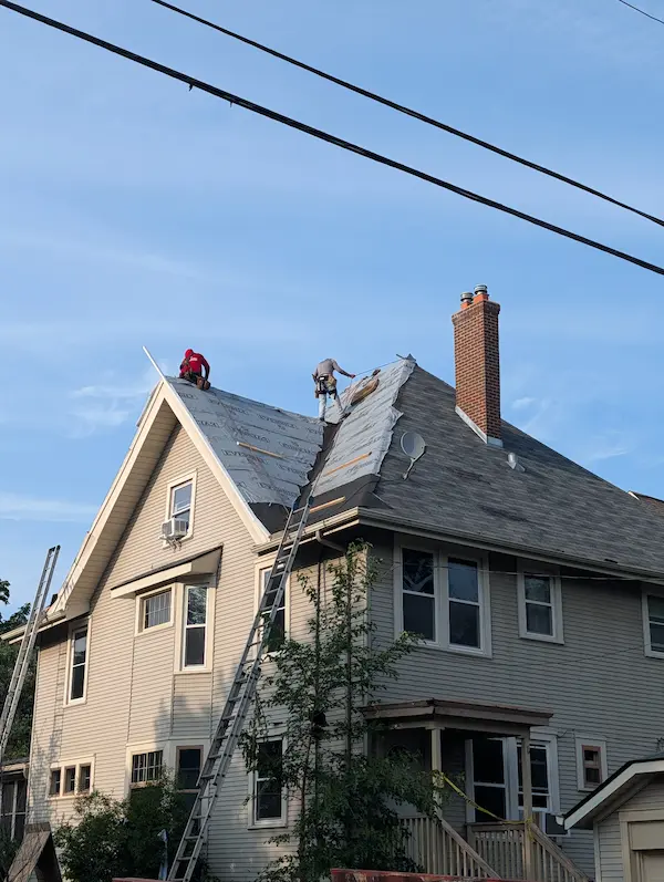 Multi-slope residential roof replacement with chimney